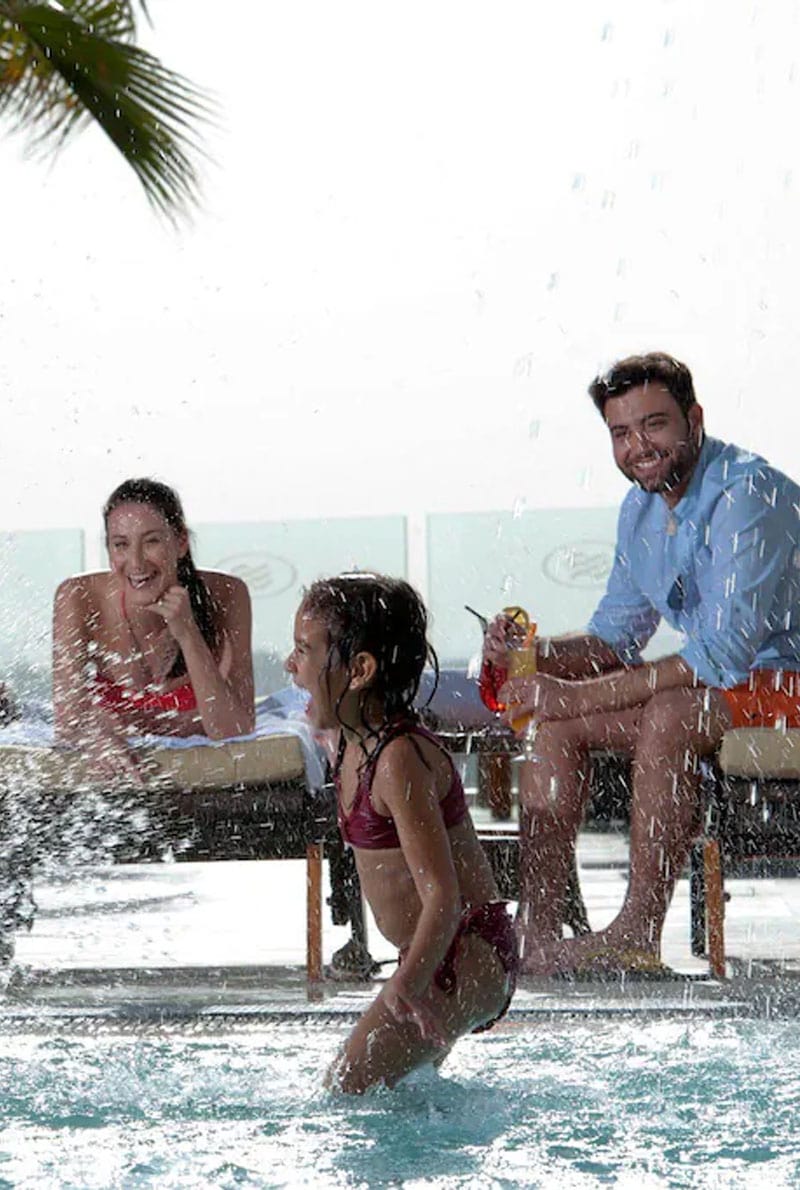 Thrilling Swimming with family in the pool area of Abu dhabi Hotel