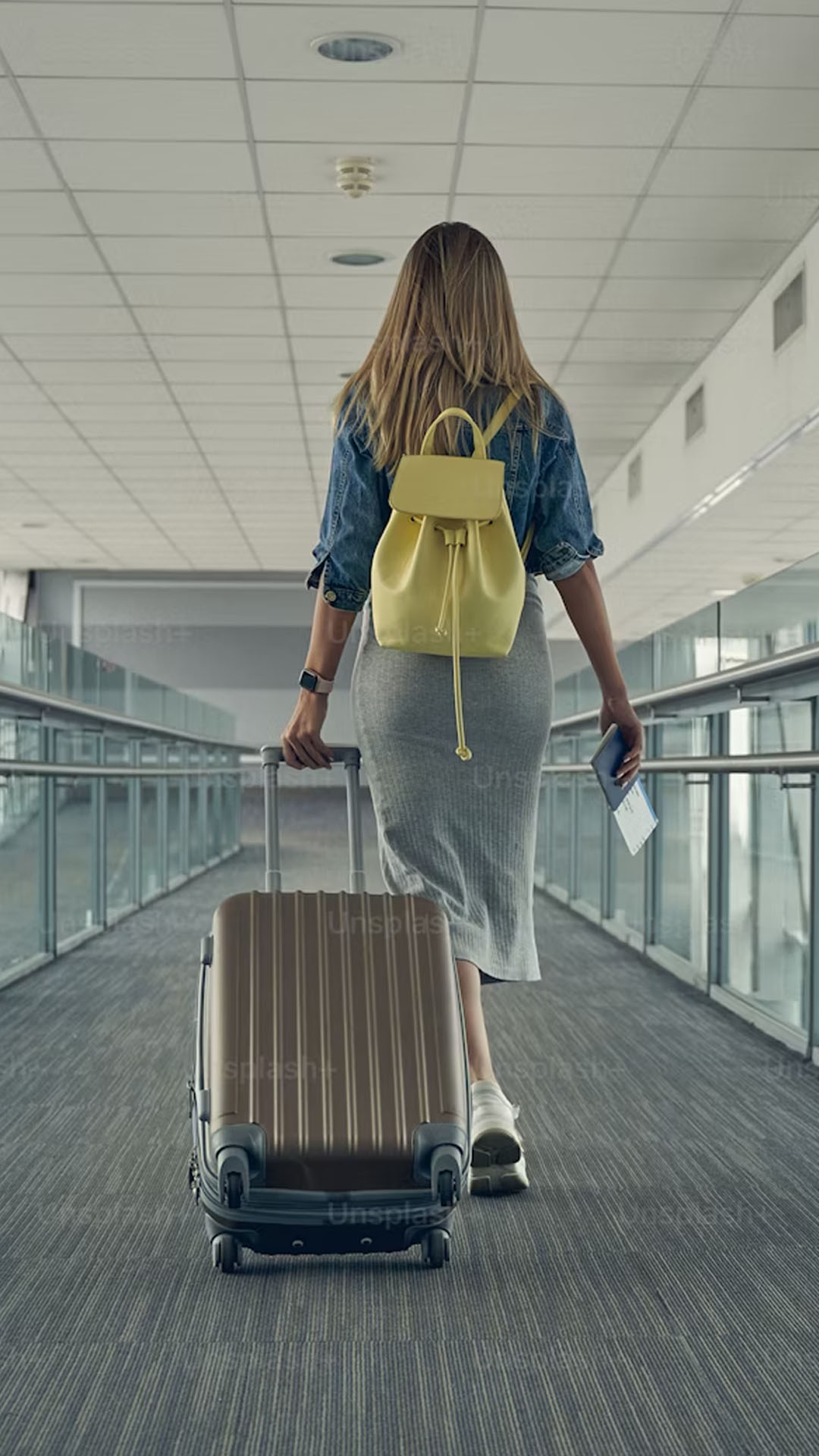 A woman pulling her luggage and ready to board